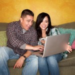 Hispanic couple editing website on computer